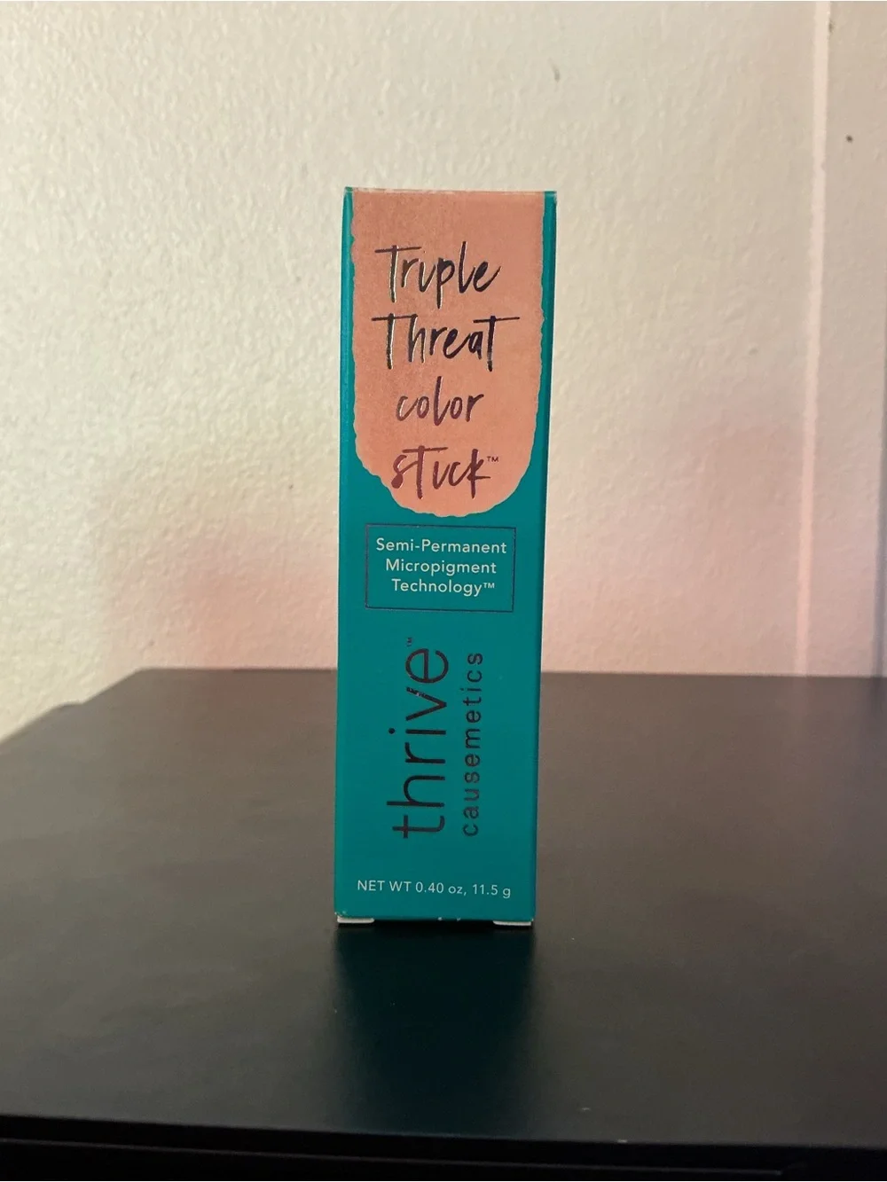 thrive causemetics Triple Threat Color Stick in Teal Packaging with gold shimmer